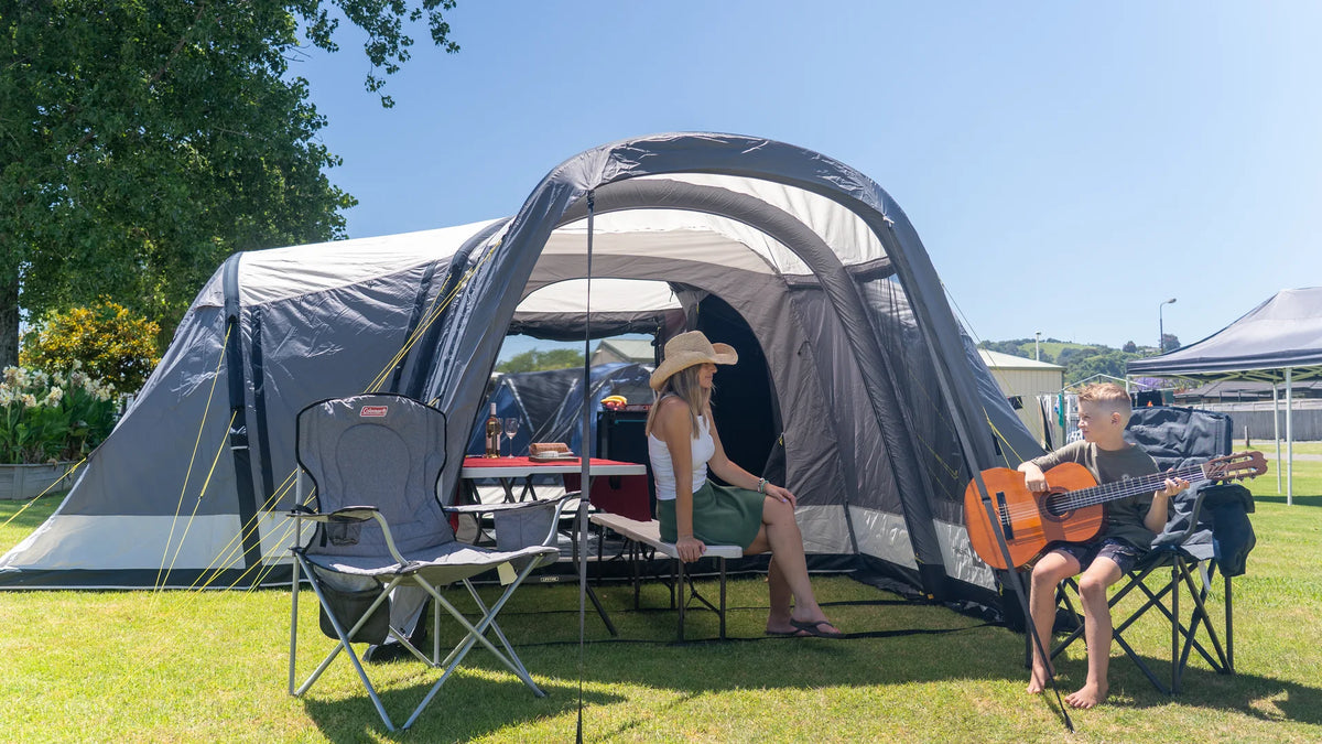 A family relaxing beside a Dwights Enterprise 3 tent